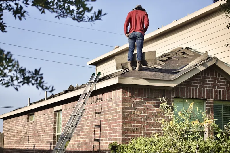 Professional roofer working on a residential roof in Eightmile